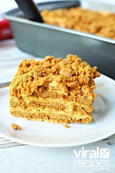 a piece of cake sitting on top of a white plate next to a baking pan