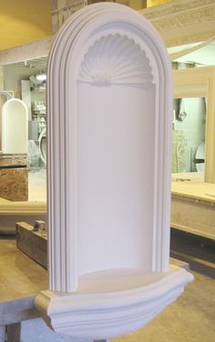 a large white fountain sitting on top of a hard wood floor