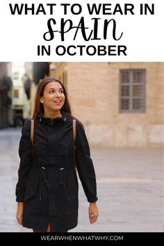 a woman walking down the street with text overlay that reads what to wear in spain in october