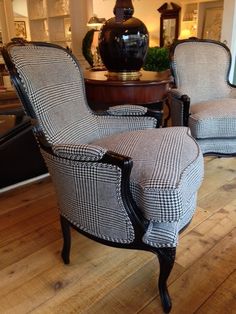 two chairs sitting next to each other on top of a hard wood floored floor