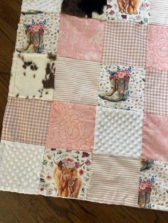 a patchwork quilt with cowgirl boots on the front and pink, white, and brown squares