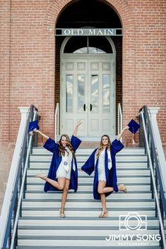 two girls in graduation gowns posing on stairs