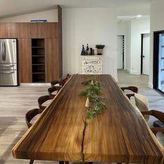 a wooden table sitting in the middle of a kitchen