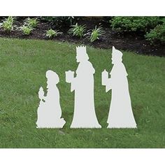 three silhouettes of people standing in the grass