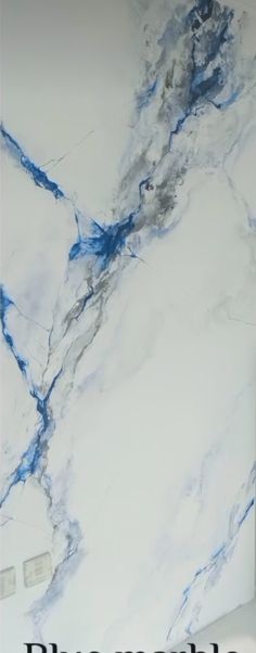 a white marble wall with blue streaks on it