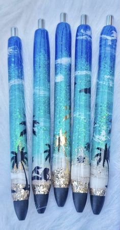 four blue and white umbrellas with palm trees on them