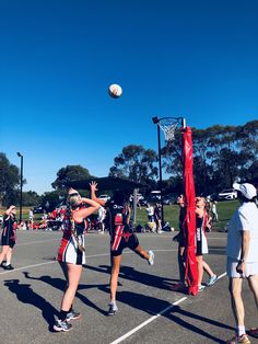 some girls are playing basketball on a court