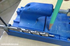 a drill is being used to make holes in the side of a piece of metal