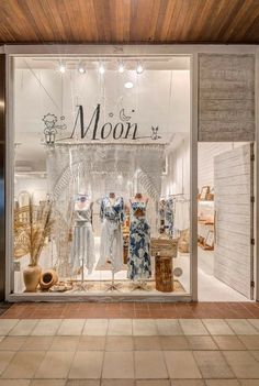 the front window of a store with clothes and baskets on display in it's windows