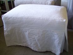 two white bedspreads sitting next to each other