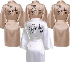 three robes with the bride and groom names on them