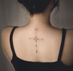 a woman with a cross tattoo on her back