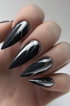 Black Matte Nails with Silver Veins Go bold with these goth winter nails! Black matte nails enhanced with metallic silver veins create a striking, trendy winter nails look. Perfect for anyone seeking an edgy and elegant style. Find more daring designs at nailhow.com and save this pin for later! Black Matte Nails With Silver Glitter, Solstice Nails Winter, Black And Silver Goth Nails, Black Gray And Silver Nails, Black Nd Silver Nails, Dark Winter Nails With Design, Silver And Black Glitter Nails, Dark Themed Nails, Black Snake Nail Design