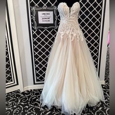 a dress on display in front of a black and white wall