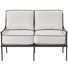 two white couches sitting next to each other on top of a black metal frame