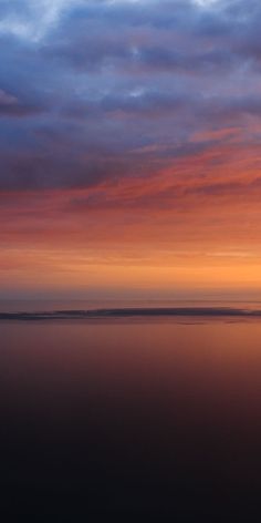 an orange and blue sunset over the ocean