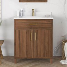 a bathroom vanity with a mirror above it and a wooden cabinet underneath the sink,