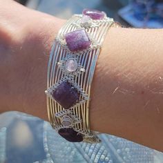 This Beautiful Unquie Cuff Bracelet Was Handmade With Silver Plated Wire. It Contains Five 10mm Square Lepidolite Stones And Four 4mm Round Lepidolite Stones. The Bracelet Is 1" Wide And Fits Wrist Sizes 6" To 7.5" Wire Cuff Bracelet, Wire Cuff, Wrap Jewelry, Jewelry Hand, Wire Weaving, Hand Crafted Jewelry, Wire Bracelet, Wire Wrap, Wire Wrapped Jewelry