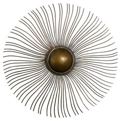 a metal sunburst is shown against a white background and has long thin lines in the center