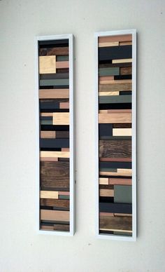 two pieces of wood are mounted on the wall next to each other, with different colors and shapes