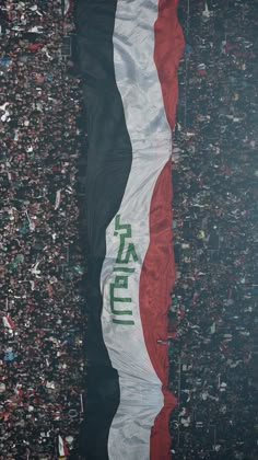 an overhead view of a large flag in the middle of a crowd