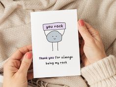 a person holding up a card that says, you rock thank you for always being my rock