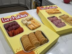 two boxes of lunchables sitting on top of a counter