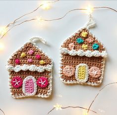 two crocheted gingerbread house ornament hanging from string