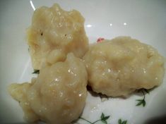 two dumplings sitting on top of a white plate