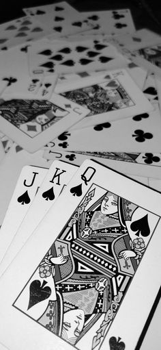 several playing cards laying on top of each other