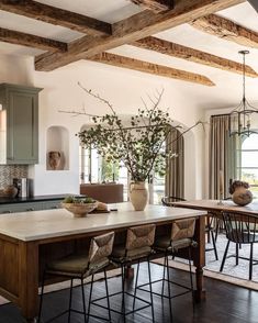 a large kitchen with wooden beams and counter tops