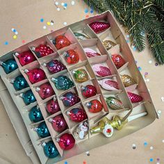 a box filled with assorted ornaments on top of a table