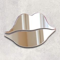 a mirror shaped like a lips on the wall