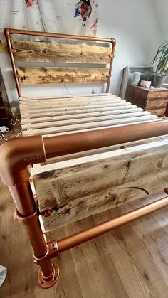 a bed frame made out of wood and pipes