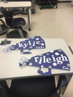 two blue and white signs sitting on top of a table