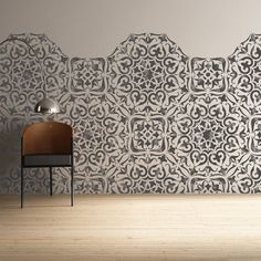 a chair sitting in front of a wall with an intricate design on it's side