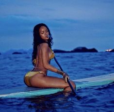 a woman sitting on a surfboard in the ocean