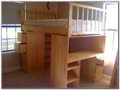 a wooden bunk bed sitting next to a window