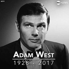 a man in a suit and tie with the name adam west on his chest, 1932 - 2017