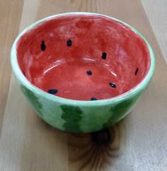 a watermelon bowl sitting on top of a wooden table