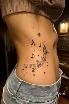 a woman's stomach with musical notes and stars on it