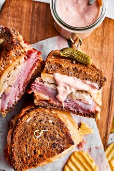 a sandwich cut in half sitting on top of a cutting board