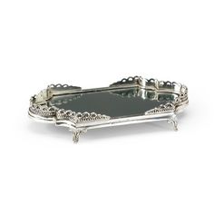 an ornate silver tray with handles and feet on the bottom, sitting on a white surface