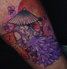 a tattoo with an image of a woman holding a parasol and flowers on her arm