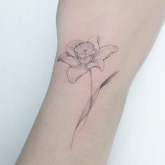 a single flower tattoo on the wrist