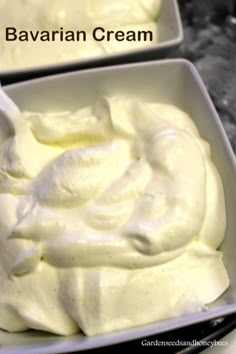 two bowls filled with cream sitting on top of a table