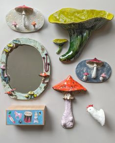 there are many different items on the table including a mirror, mushrooms and other things