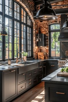 an industrial style kitchen with black cabinets and large windows