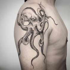 an octopus tattoo on the back of a man