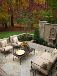 an outdoor patio with seating and fire place